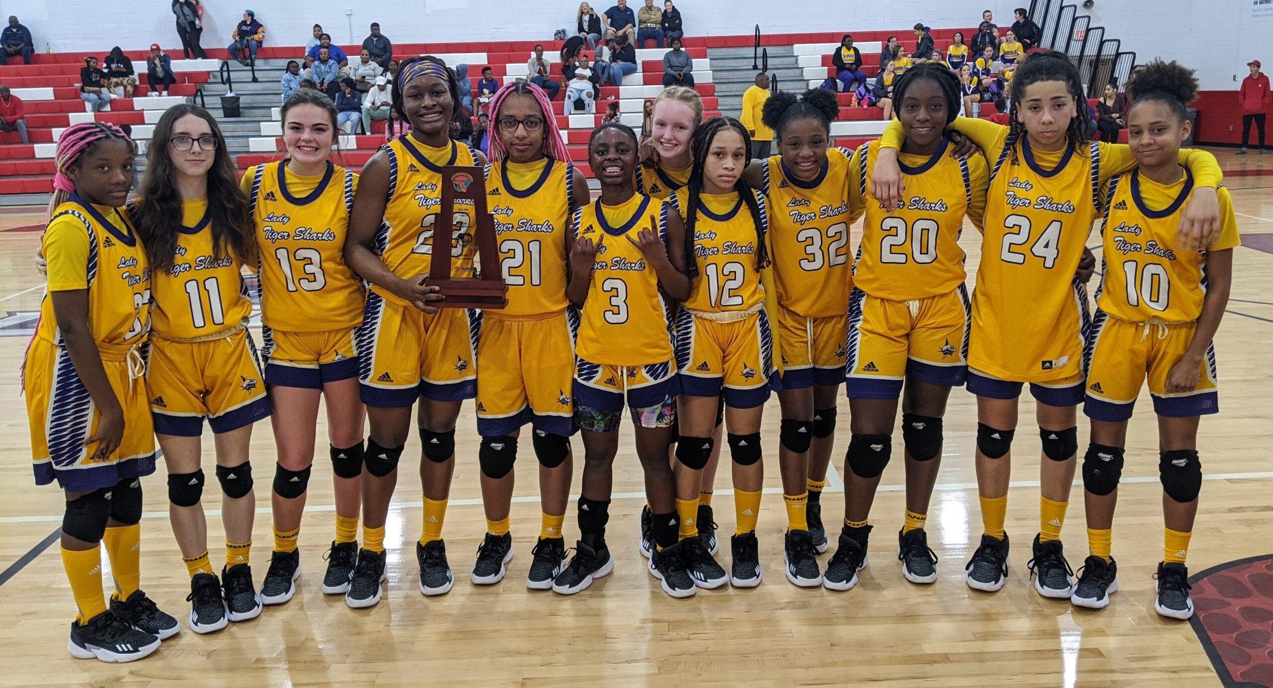 lady tiger sharks with trophy